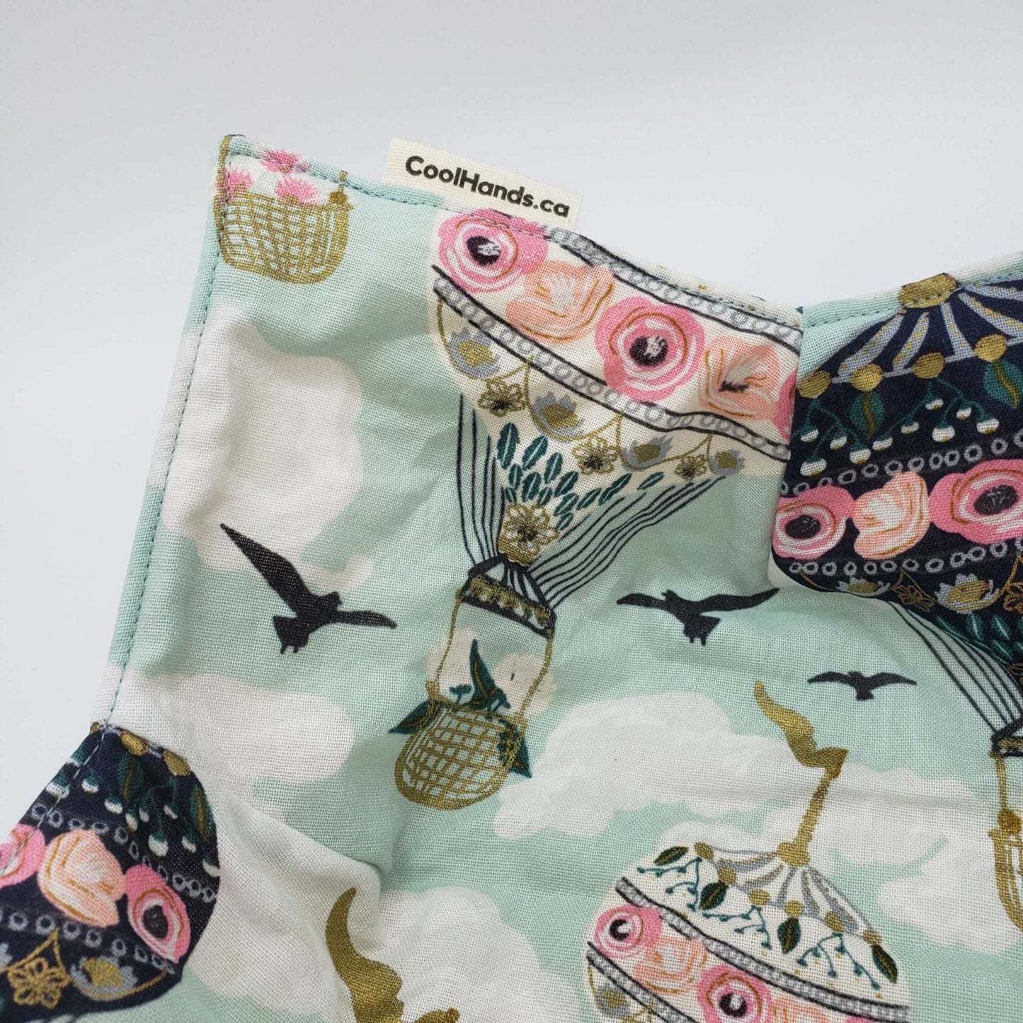 Microwavable bowl cozy with whimsical hot air balloon design and floral back for heat protection and style